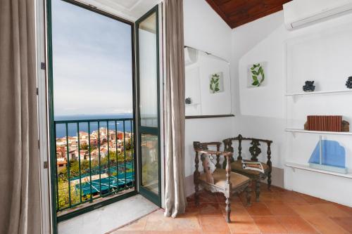 a room with a large window with a view of the ocean at Villa San Francesco in Massa Lubrense