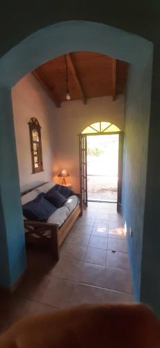 a bedroom with a bed and an open doorway at Aquicho in San Marcos Sierras