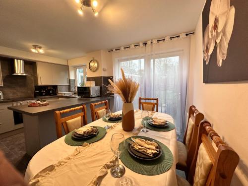 a kitchen with a table with plates of food on it at Detached 3-Bedroom Home in a Quiet Derby Neighbourhood in Mickleover in Derby
