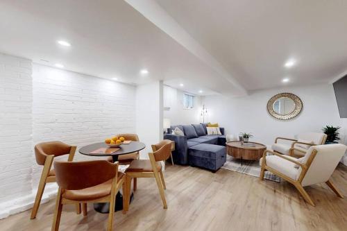 a living room with a couch and a table at Fresh and Modern Guest Suite in Toronto