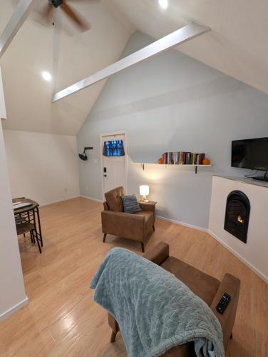 a living room with a couch and a fireplace at Willamette Cottage in Salem