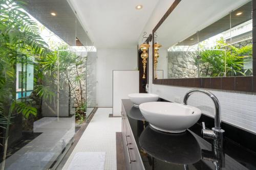 two sinks in a bathroom with plants at Laguna luxury pool villa 3 bedroom in Phuket