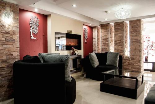 a living room with two couches and a table at Hotel Imperial in Ambato