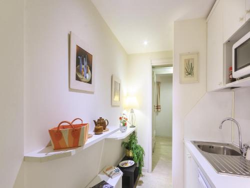 a kitchen with white walls and a sink at Trust-trastevere in Rome