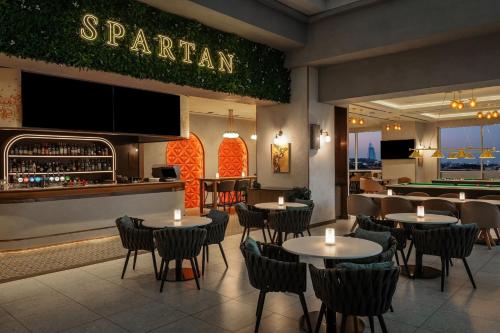 a restaurant with tables and chairs and a bar at Sheraton Mall of the Emirates Hotel, Dubai in Dubai