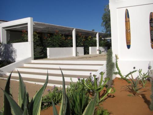 a white building with stairs and plants at Le Jardin de L'isle in Ifaty