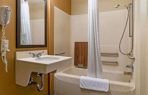 a bathroom with a sink and a tub and a shower at Extended Stay America Suites - Detroit - Novi - Orchard Hill Place in Northville