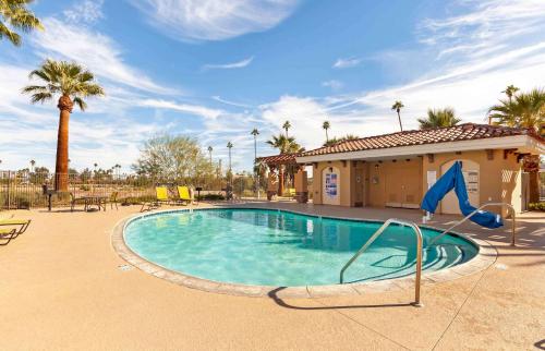 a swimming pool with a slide in a resort at Extended Stay America Suites - Palm Springs - Airport in Palm Springs