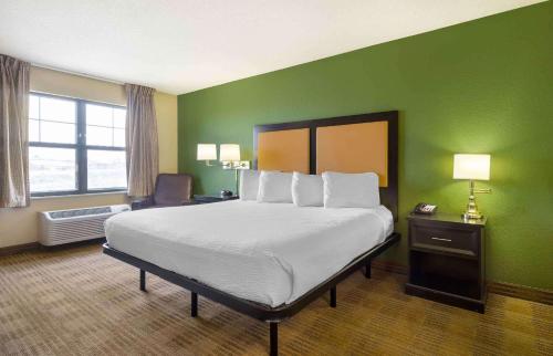 a bedroom with a large bed and a green wall at Extended Stay America Suites - Tacoma - South in Tacoma