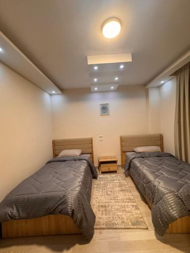 two beds in a room with two beds sidx sidx sidx at Luxury - 2 Bedroom Apartment B7 in Madinaty