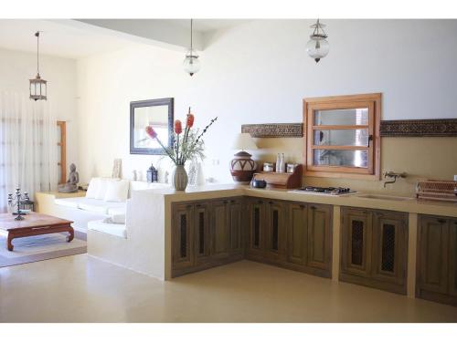a living room with a kitchen and a couch at Villa Luna in Sumartin