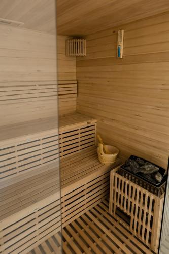 a wooden sauna with a wooden bench in a room at Complex Turistic Capus & Spa in Căpuşu Mare