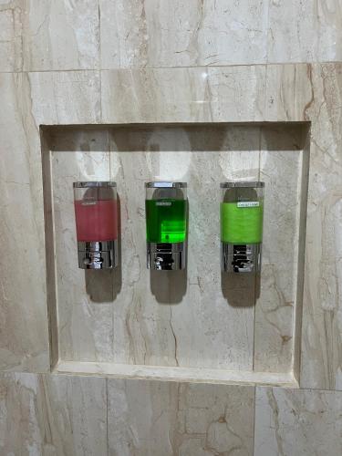 a couple of green and red lights on a wall at Mandhasativa Homestay in Singaraja