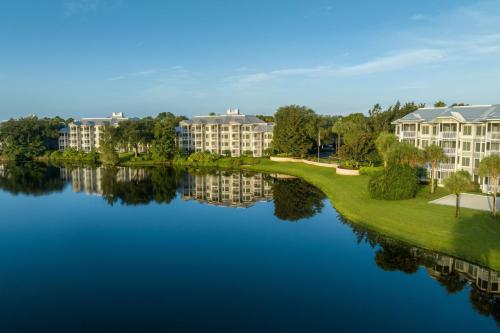 a view of a resort with a lake and buildings at Marriott's Cypress Harbour Villas in Orlando