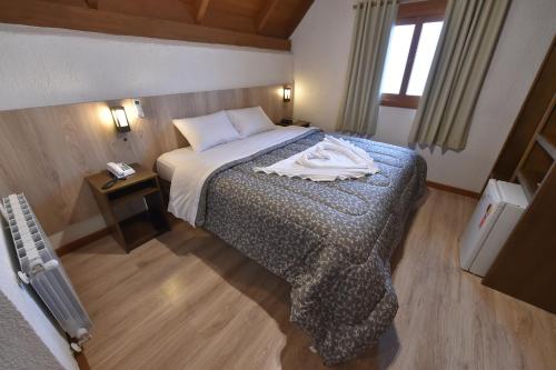 Ένα ή περισσότερα κρεβάτια σε δωμάτιο στο Hotel Villa Aconchego de Gramado
