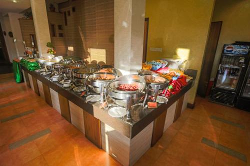 a buffet line with many pots of food at Atithi Resort & Spa in Pokhara