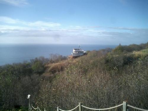 a lighthouse on top of a hill near the ocean at Alaska Adventure Cabins in Homer