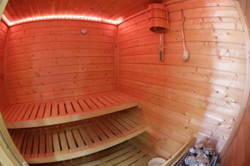 an empty sauna with wooden walls and wooden floors at Aurora in Castione della Presolana