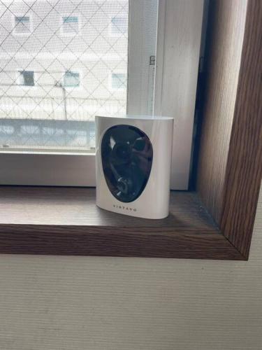 a clock sitting on a window sill next to a window at UNITED GARDEN hotel 2 in Utsunomiya