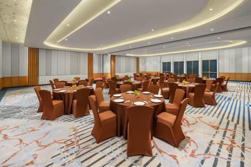 a large banquet hall with tables and chairs at Four Points by Sheraton Bintan, Lagoi Bay in Lagoi