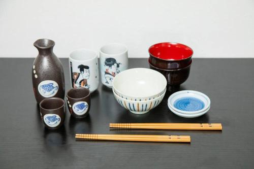 a group of bowls and chopsticks on a table at NIYS apartments 55 type in Tokyo