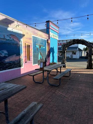 a group of benches sitting outside of a building at Coastal Inn and Suites in Long Beach