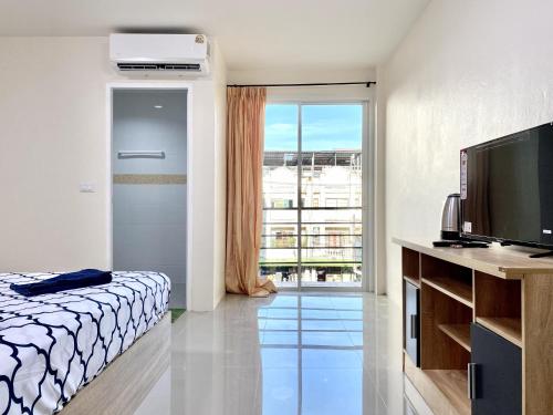 Ένα ή περισσότερα κρεβάτια σε δωμάτιο στο Vista Residence Patong