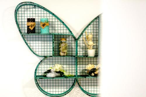 a shelf in the shape of a heart with items on it at Apartments and Rooms Villa Erede in Split