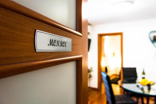 a door to a living room with a sign on it at Apartments and Rooms Villa Erede in Split