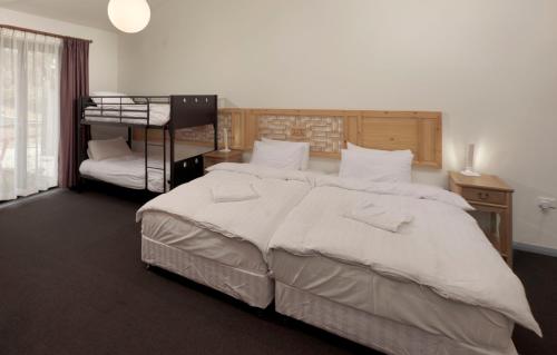 a bedroom with a large bed and a bunk bed at Sinofield Edu-Retreat in Leura
