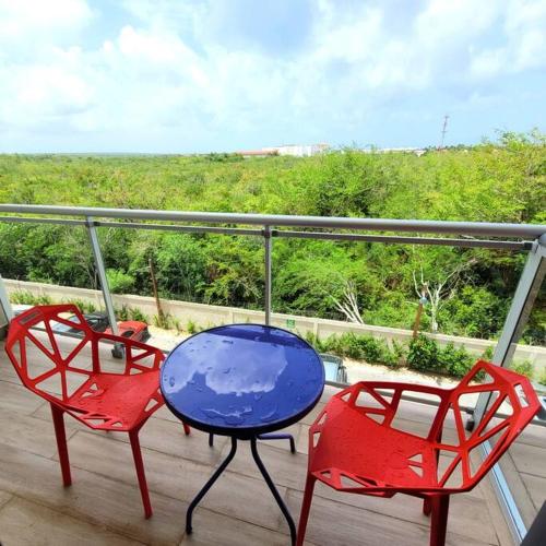 two chairs and a blue table on a balcony at Vibe Residence Hotelstyle NO KITCHEN STUDIO close to beach in La Laguna