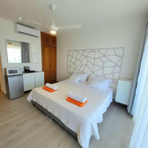 a bedroom with a white bed with two towels on it at Vibe Residence Hotelstyle NO KITCHEN STUDIO close to beach in La Laguna