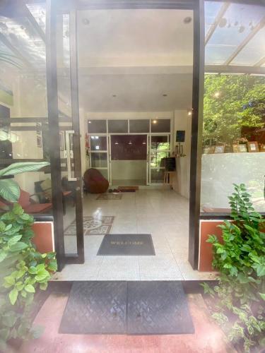 a large glass door of a house with a patio at The Journey House Lifestyle Boutique Hotel in Kanchanaburi