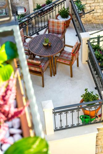 a patio with a table and chairs on a balcony at Apartments and Rooms Villa Erede in Split