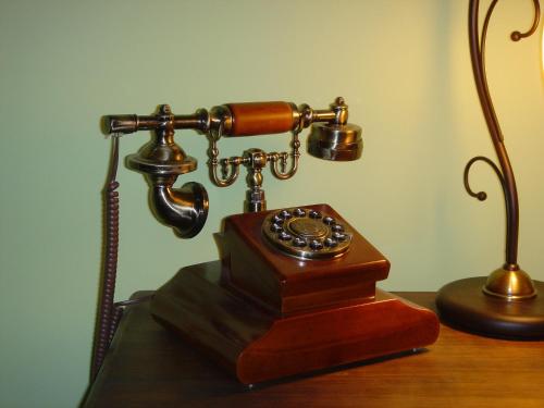a telephone sitting on a table next to a lamp at Posada Carpe Diem in Liérganes