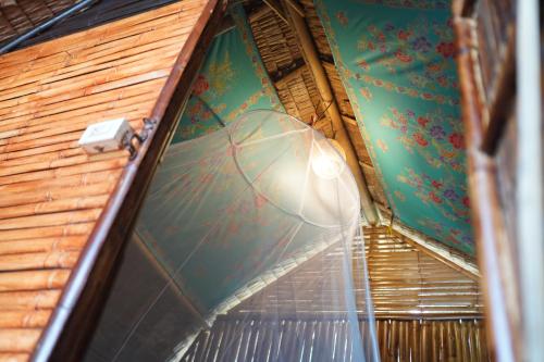 a tennis racket is hanging from a ceiling at KRABI BAMBOO KINGDOM at AOLUEK PARADISE in Ao Luk