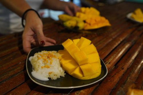 a plate of mangoes and other food on a table at KRABI BAMBOO KINGDOM at AOLUEK PARADISE in Ao Luk