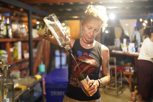 a woman holding a glass jar in a bar at KRABI BAMBOO KINGDOM at AOLUEK PARADISE in Ao Luk