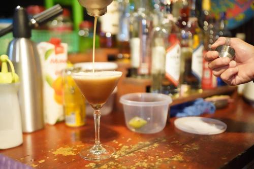 a drink is being poured into a glass on a counter at KRABI BAMBOO KINGDOM at AOLUEK PARADISE in Ao Luk