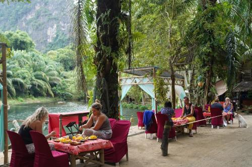 a group of people sitting at a table with food at KRABI BAMBOO KINGDOM at AOLUEK PARADISE in Ao Luk