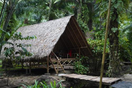 a hut with a thatched roof in the jungle at KRABI BAMBOO KINGDOM at AOLUEK PARADISE in Ao Luk