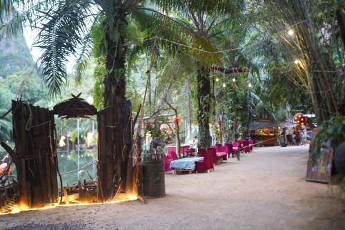 a group of tables and chairs under a tree at KRABI BAMBOO KINGDOM at AOLUEK PARADISE in Ao Luk