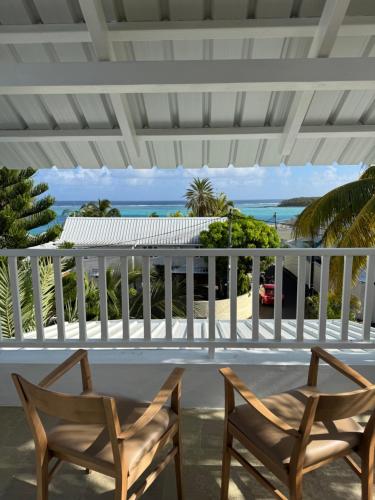 two chairs on a porch with a view of the ocean at Blue Paradise Villa & Apartments in Blue Bay