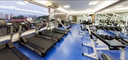 a gym with rows of treadmills and machines at Flat Araucaria Plaza in Ribeirão Preto