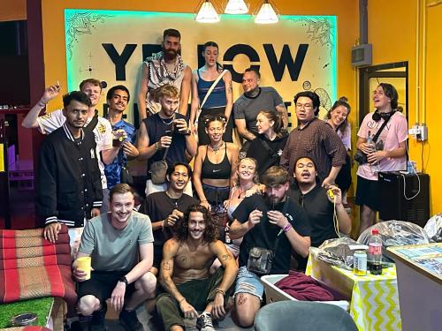 a group of people posing for a picture in a room at Yellow Fellow Hostel in Chiang Mai