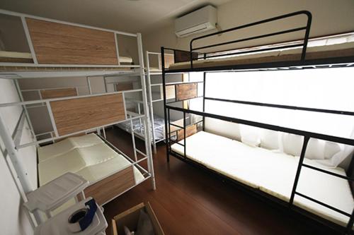 Postel nebo postele na pokoji v ubytování Mount Fuji Omotenashi Guesthouse
