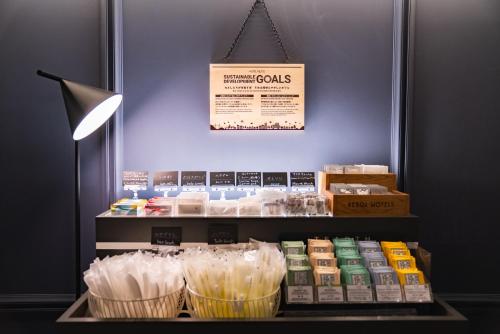 a store with a display of food items on a shelf at Hotel Resol Yokohama Sakuragicho in Yokohama