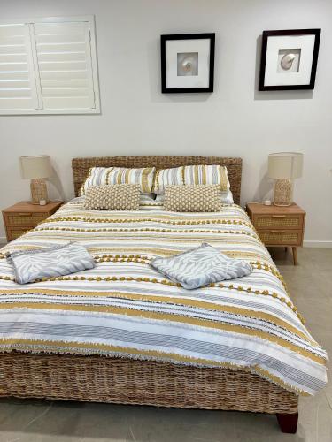 a bed with two pillows on it in a bedroom at Beachside retreat in Caloundra