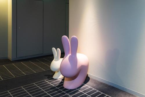 two rabbits sitting on the floor in a room at Hotel Resol Yokohama Sakuragicho in Yokohama