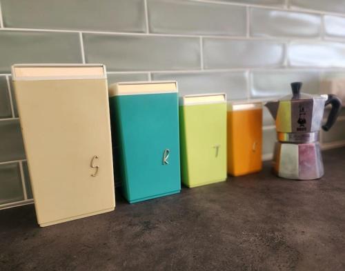 a row of different colored boxes sitting on a counter at Rosebud Retro Retreat in Rosebud